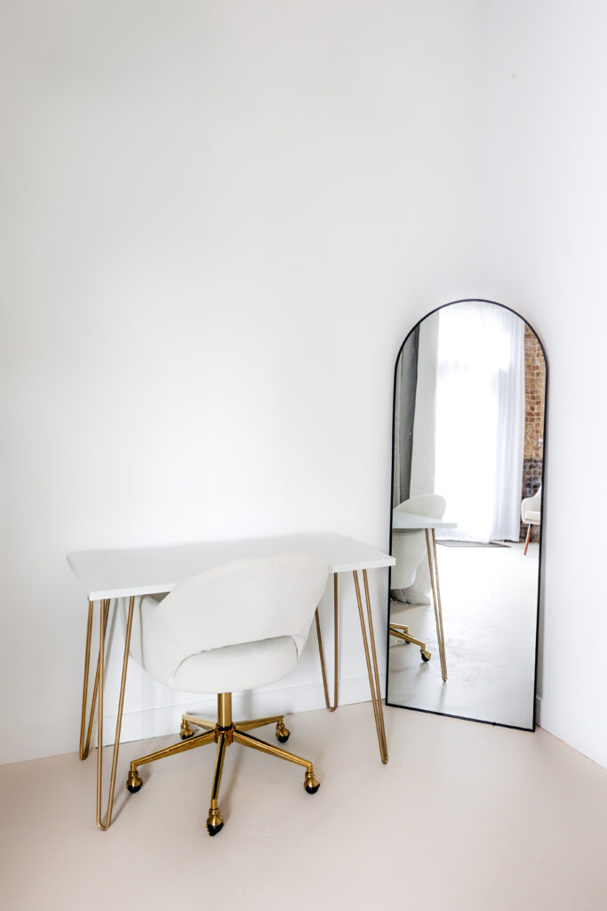 Natural light in a branding photoshoot set up with a desk and chair and mirror